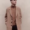man in brown coat and black pants