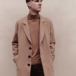 man in brown coat and black pants