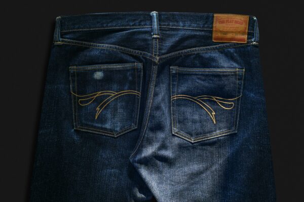 a pair of jeans with a logo on the front