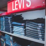 blue denim jeans on black plastic rack