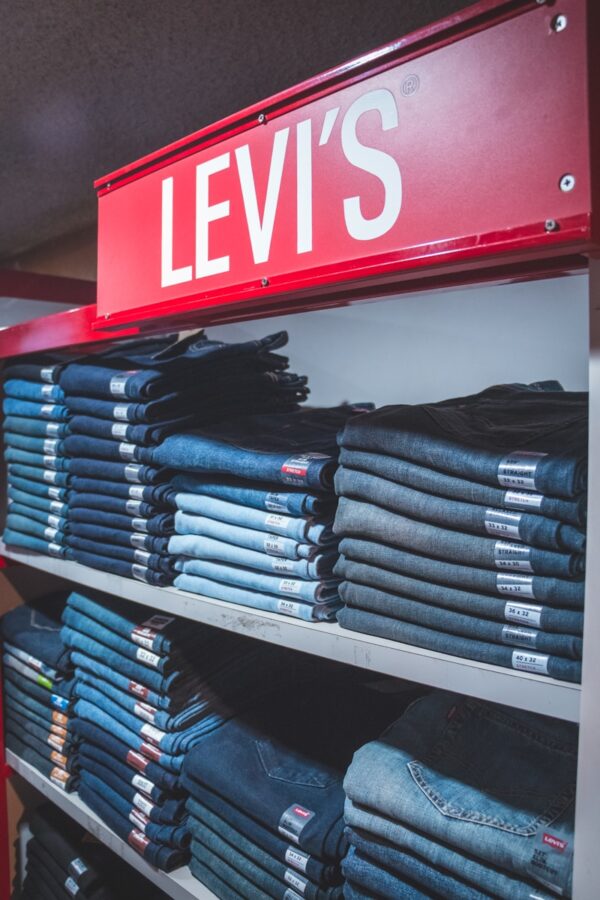 blue denim jeans on black plastic rack